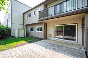 Winnipeg townhouse for rent - A balcony with a glass railing is on the second floor of a house.