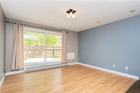 Winnipeg townhouse for rent - A room with a sliding glass door and wooden flooring.