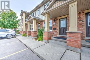 London South (South U) townhouse for rent - A white car is parked on the street in front of a brick building with a porch.