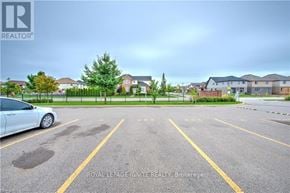 London South (South U) townhouse for rent - A white car is parked in a parking lot with yellow lines.