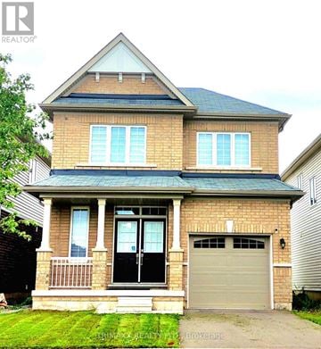 Thorold (Hurricane/Merrittville) apartment for rent - A house with a brick facade and a grey garage door.