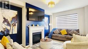 Thorold (Hurricane/Merrittville) apartment for rent - A living room with a fireplace and a painting on the wall.