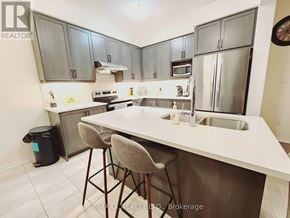 Thorold (Hurricane/Merrittville) apartment for rent - A kitchen with a white counter top and grey cabinets.