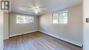 Grande Prairie apartment for rent - A room with a window and a wooden floor.