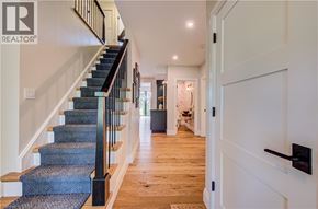 Kitchener apartment for rent - A hallway with a staircase and a door on the right.