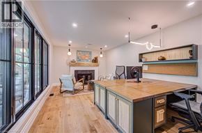 Kitchener apartment for rent - A well-lit room with a fireplace and a desk with a computer.