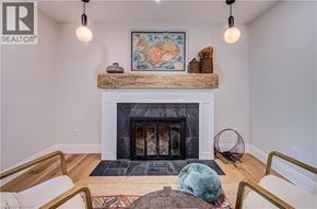 Kitchener apartment for rent - A living room with a fireplace and a painting above it.