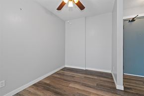 Chilliwack apartment for rent - A room with a ceiling fan and wooden flooring.