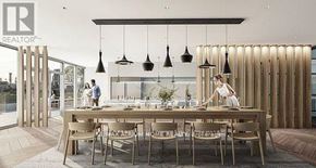 Toronto (South Riverdale) condo for rent - A modern dining area with a long table and chairs, and pendant lights hanging above.