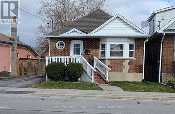 Oshawa (Central) apartment for rent - A house with a white front porch and a brick exterior.