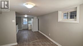 Oshawa (Central) apartment for rent - A room with a refrigerator and a window.