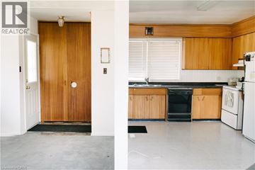 Waterloo apartment for rent - A kitchen with wooden cabinets and a black fridge.