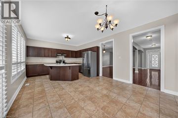 Cambridge apartment for rent - A well-lit kitchen with brown cabinets and a tile floor.