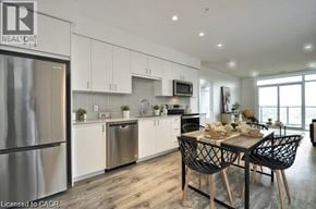 Cambridge condo for rent - A modern kitchen with a dining table set for two.