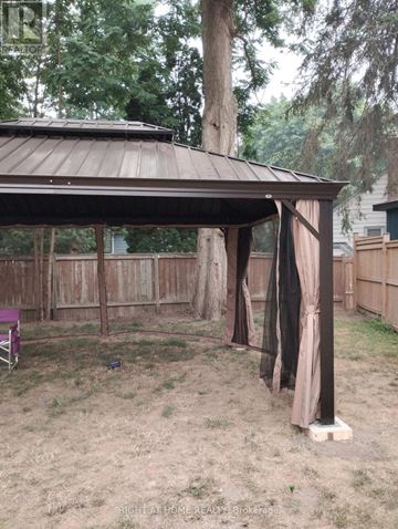 London East (East M) apartment for rent - A gazebo with a brown roof is surrounded by a wooden fence.