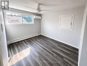 London East (East I) apartment for rent - A room with a ceiling fan and a window with a view of a brick building outside.