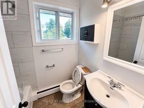 London East (East I) apartment for rent - A white bathroom with a toilet, sink, and window.