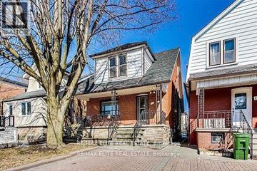 Toronto (Oakwood Village) apartment for rent - A house with a red brick facade and a white house with a grey roof are shown.