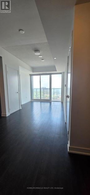 Toronto (Banbury-Don Mills) condo for rent - A long hallway with a sliding glass door at the end.