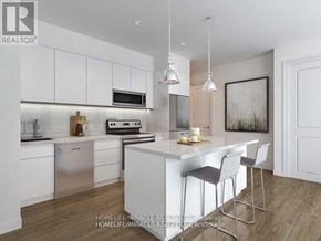 Brantford condo for rent - A modern kitchen with white cabinets and a wooden floor.