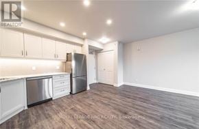 Niagara Falls (Hospital) condo for rent - A kitchen with white cabinets and a stainless steel dishwasher.