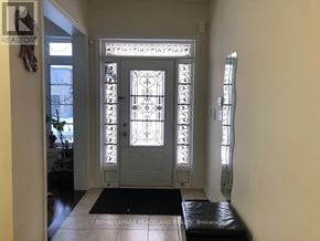 Aurora apartment for rent - A white door with a glass panel and ironwork design is the focal point of the image.