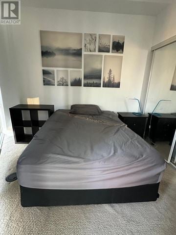 Toronto (Bay Street Corridor) condo for rent - A bedroom with a bed, nightstands, and pictures on the wall.