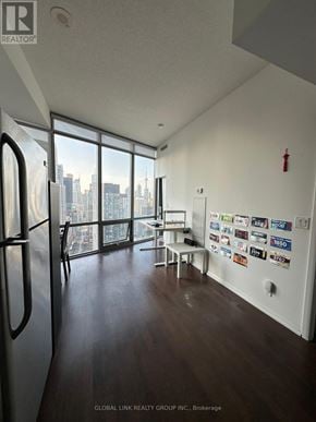 Toronto (Bay Street Corridor) condo for rent - A room with a view of the city through large windows.