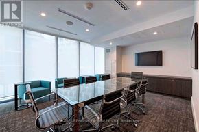 Toronto (Niagara) condo for rent - A conference room with a glass table and chairs.