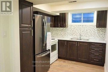 Toronto (Newtonbrook East) apartment for rent - A kitchen with a refrigerator, cabinets, and a window.