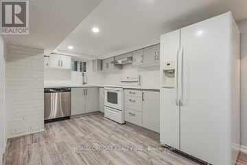 Toronto (Trinity-Bellwoods) apartment for rent - A white kitchen with a refrigerator, dishwasher, and oven.