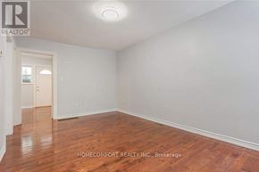 Toronto (Trinity-Bellwoods) apartment for rent - A room with wooden flooring and white walls, with a doorway leading to another room.