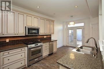 Markham (Cornell) apartment for rent - A kitchen with granite countertops and a stove top oven.