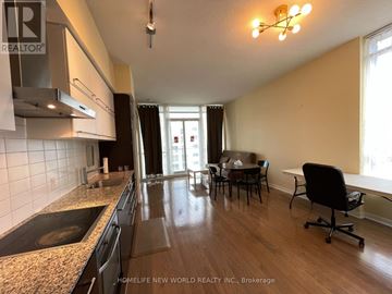 Toronto (Bay Street Corridor) condo for rent - A kitchen with a sink, stove, and a dining table with chairs.