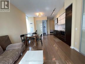 Toronto (Bay Street Corridor) condo for rent - A living room with a couch, chairs, and a dining table.
