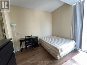 Toronto (Bay Street Corridor) condo for rent - A bedroom with a bed, desk, and chair.