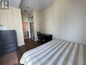Toronto (Bay Street Corridor) condo for rent - A bedroom with a bed, desk, and chair.