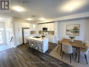 Russell townhouse for rent - A kitchen with a dining table and chairs.