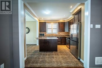 Milton (Ha Harrison) apartment for rent - A kitchen with a brown island in the middle.