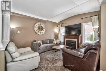 Oakville (Jc Joshua Creek) apartment for rent - A living room with a brown leather couch and a white chair.