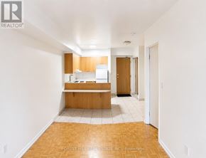Toronto (Church-Yonge Corridor) condo for rent - A kitchen with white walls and wooden floors.