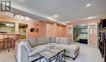 Pickering (Amberlea) apartment for rent - A living room with a grey couch and a coffee table.