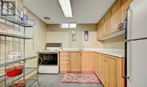 Pickering (Amberlea) apartment for rent - A kitchen with wooden cabinets and a white refrigerator.