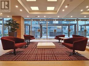 Toronto (Waterfront Communities) condo for rent - A waiting area with red chairs and a carpet with a grid pattern.
