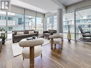 Toronto (Waterfront Communities) condo for rent - A living room with a couch, chair, and a vase.