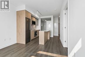 Toronto (Regent Park) condo for rent - A modern kitchen with wooden cabinets and a central island.