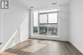 Toronto (Regent Park) condo for rent - A room with a large window and a wooden floor.