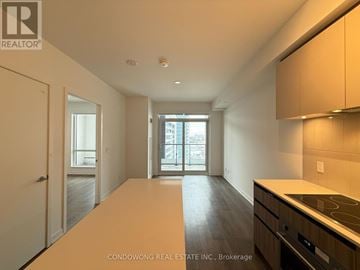 Vaughan (Beverley Glen) condo for rent - A spacious kitchen with wooden cabinets and a stove top oven.
