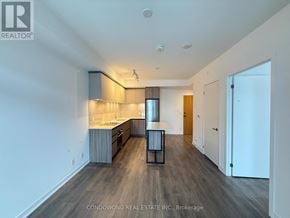 Vaughan (Beverley Glen) condo for rent - A spacious kitchen with wooden floors and white walls.