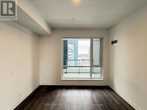 Vaughan (Beverley Glen) condo for rent - Empty room with a window and a view of the city.